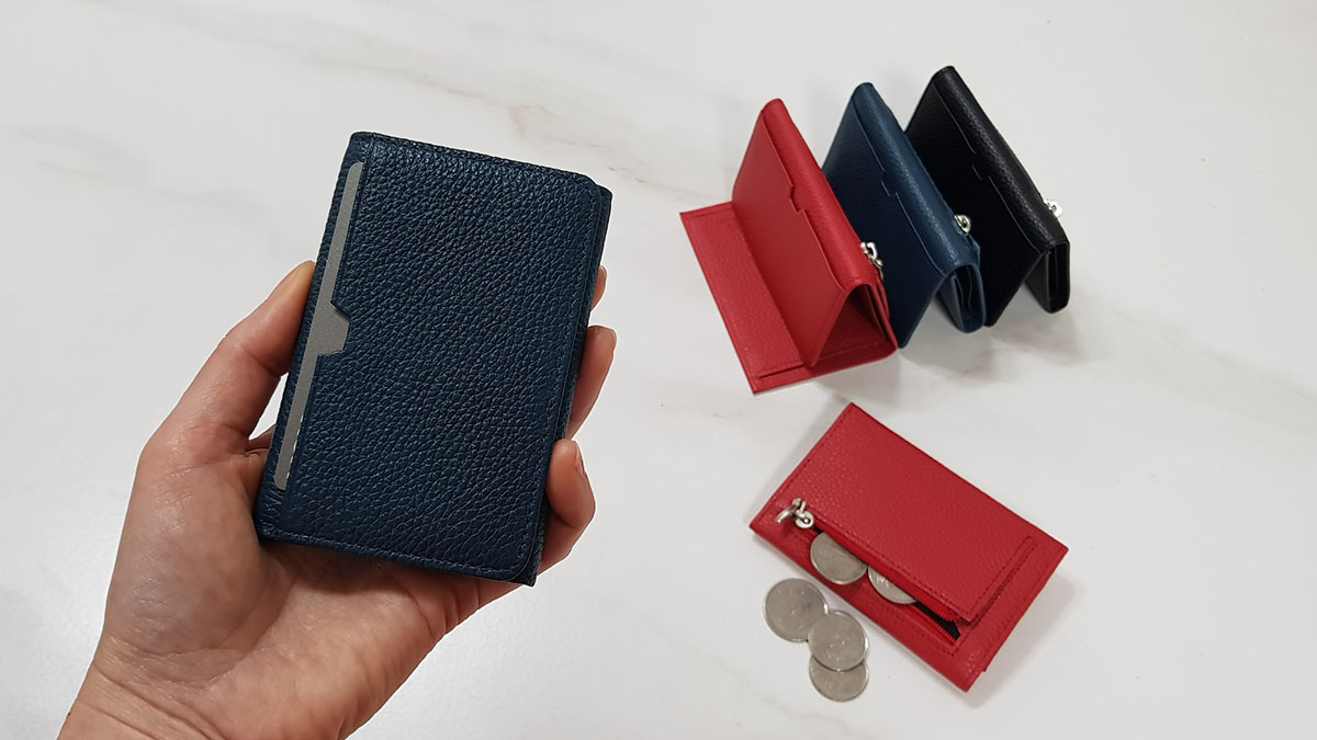 This tiny wallet surprisingly fits bills coins and cards all at once.