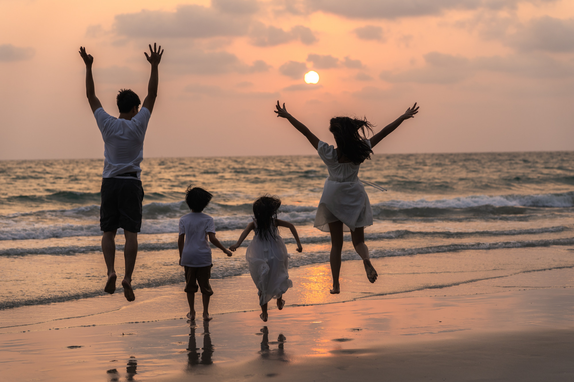asian-young-happy-family-enjoy-vacation-on-beach-in-evening-dad-mom-and-kid-relax-running-together-near-sea-while-silhouette-sunset-lifestyle-travel-holiday-vacation-summer-concept (1).jpg
